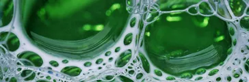 Green colored liquid with foam bubbles