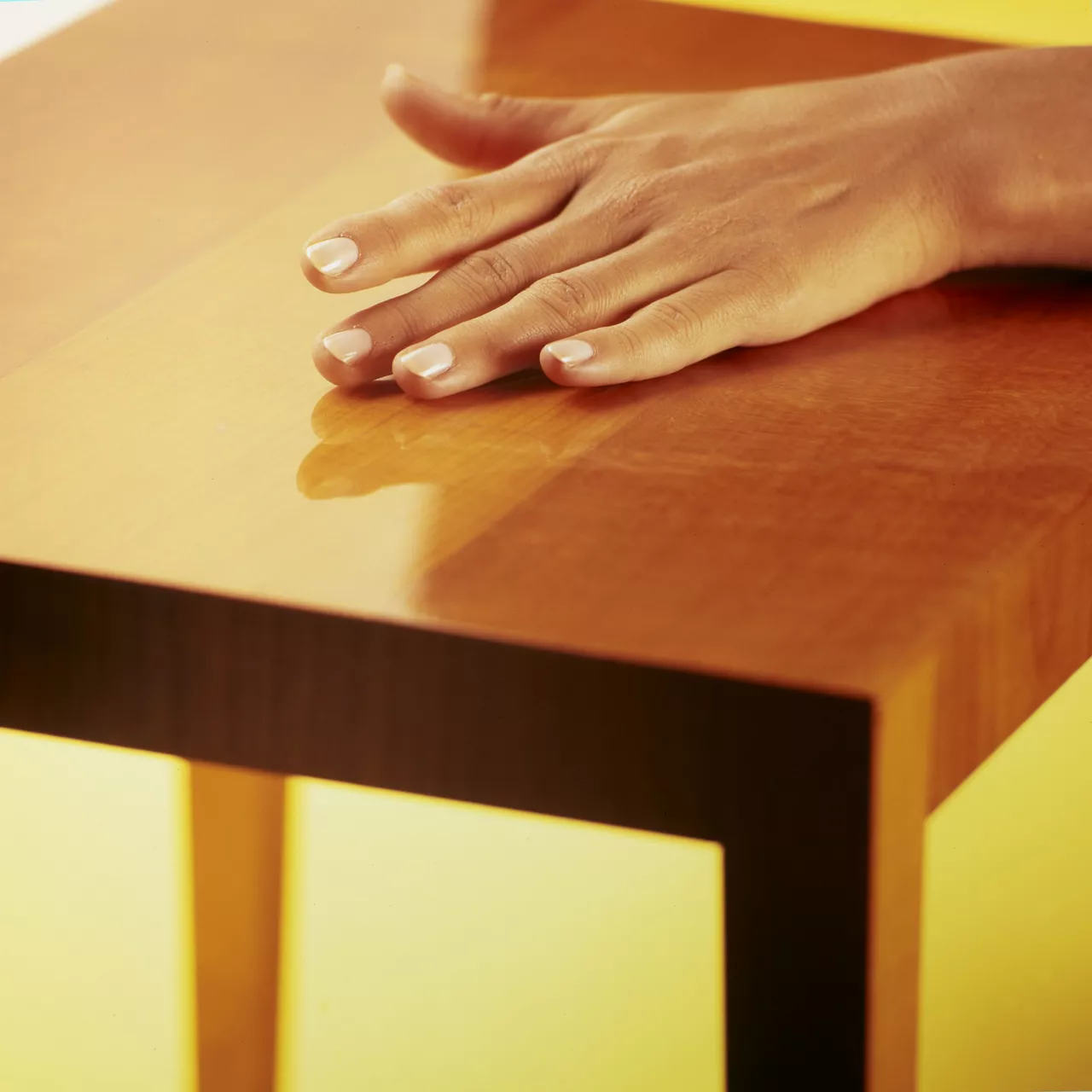 Hand on wood table  