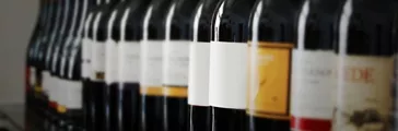 A row of wine bottles on a shelf