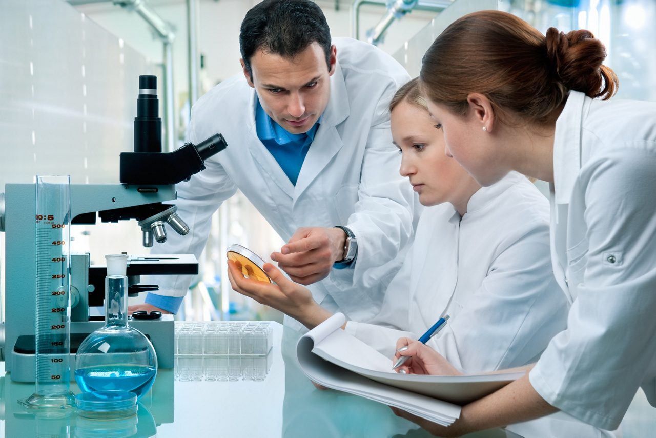 Group of three scientists working in the laboratory