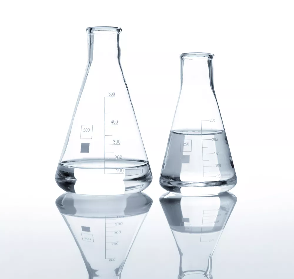 Two laboratory flasks with a clear liquid, isolated on a white background.