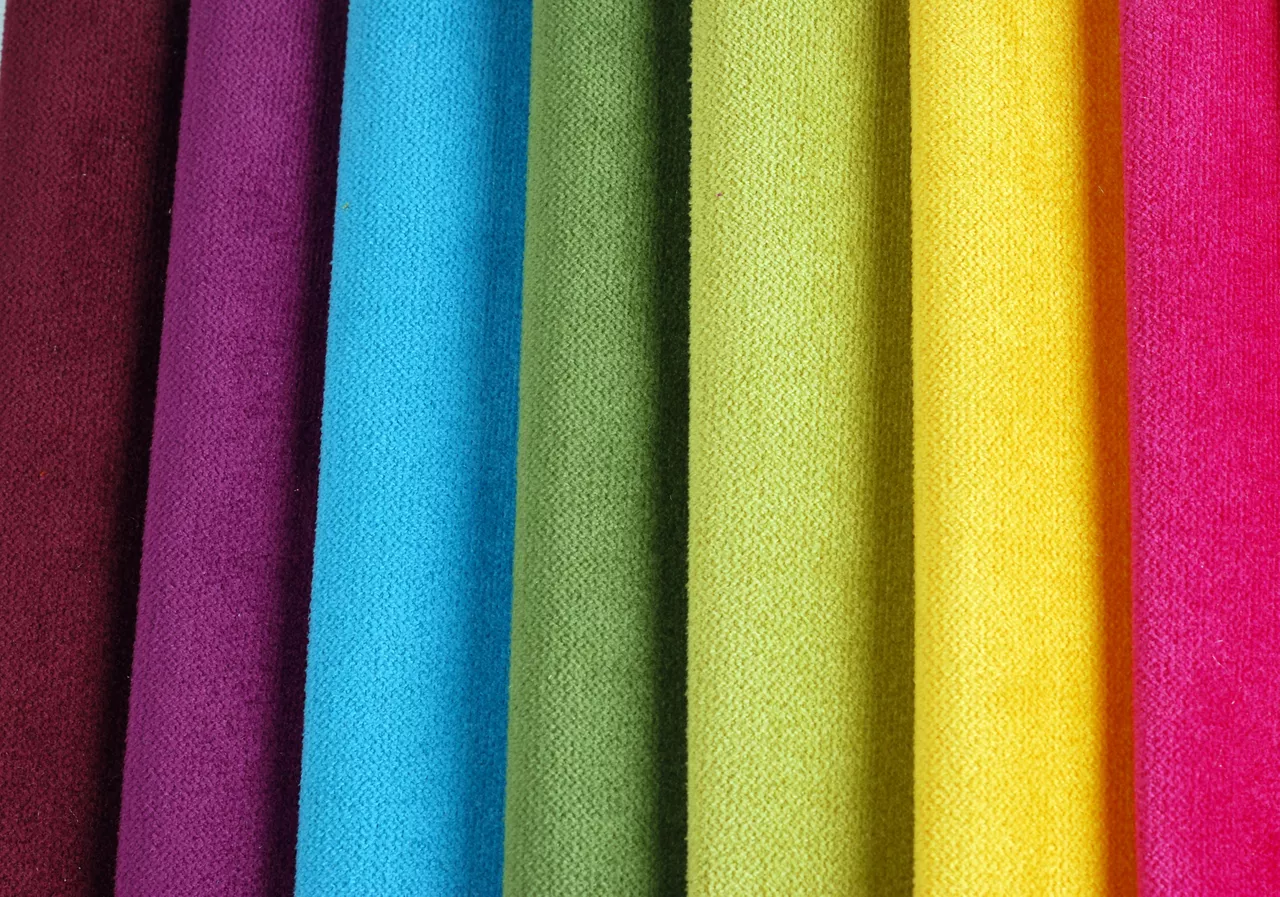 Bright collection of colorful velour textile samples. Fabric texture background