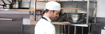 Kitchen cook cleaning dishes