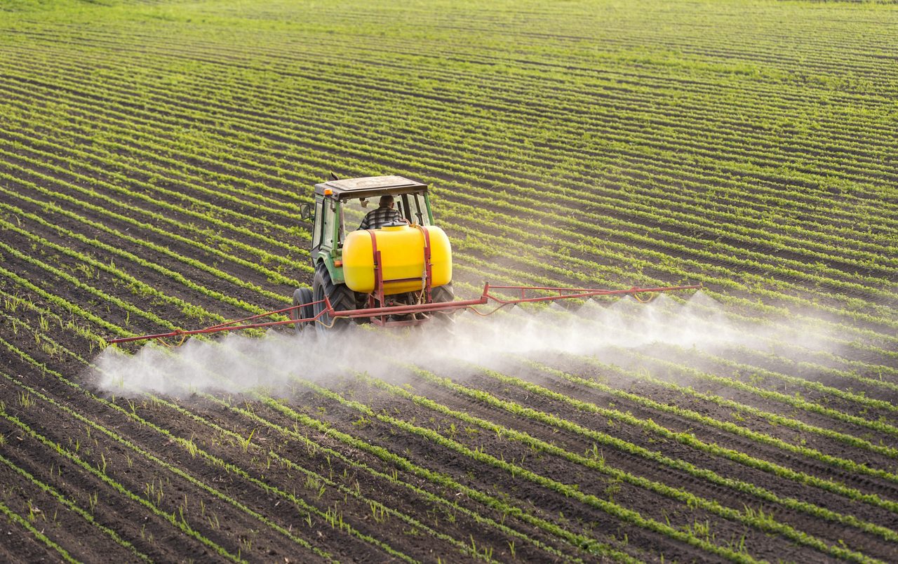 Tractor spraying crops