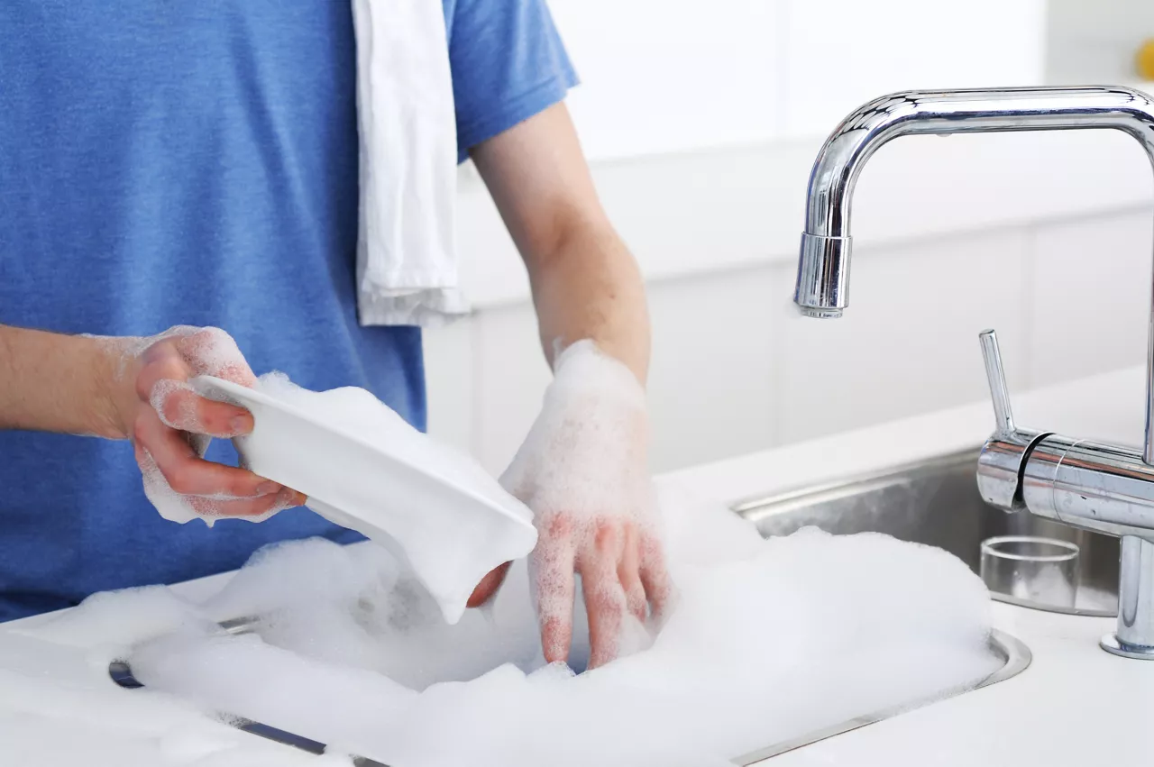 A man washing dishes