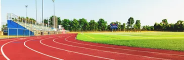 Running track in a sports stadium toward sunset