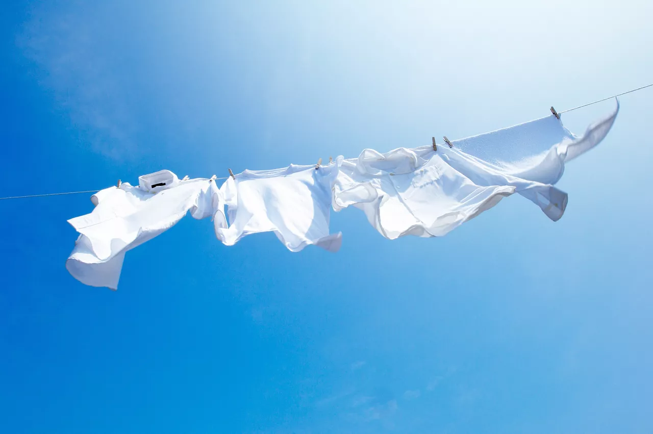 White clothes hanging on laundry line 