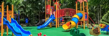 Colorful Playground with Green Elastic Rubber Floor for Children in the Park