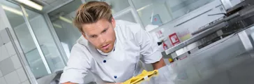 Man cleaning counter  