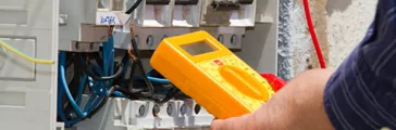 electrician at work with an electric panel