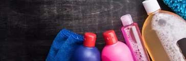 Cleaning products and tools on a wooden floor