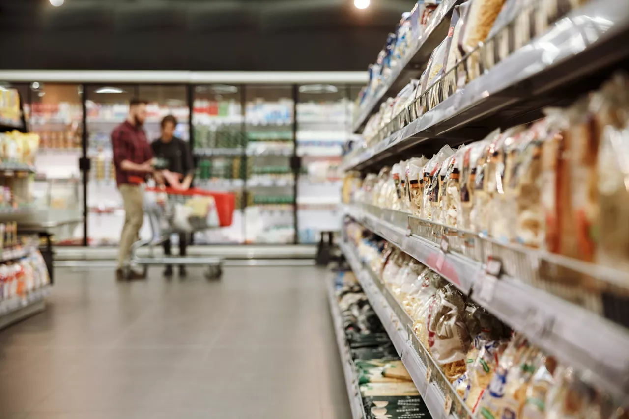 Concentrated view of young couple in supermarket choosing products