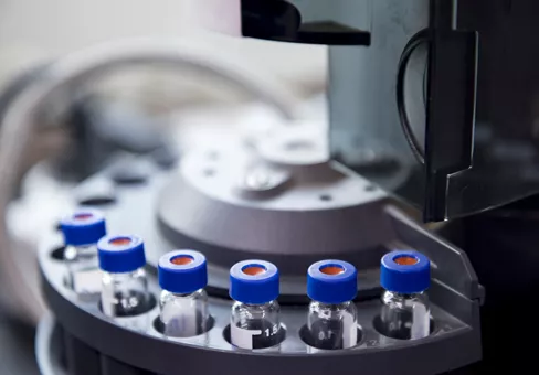 Vials are arranged in the auto-sampler for the lab equipment.