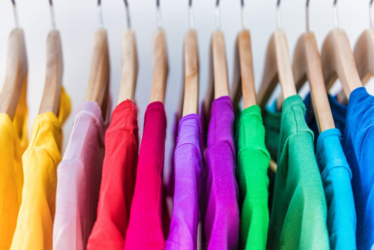 Fashion clothes on clothing rack - bright colorful closet