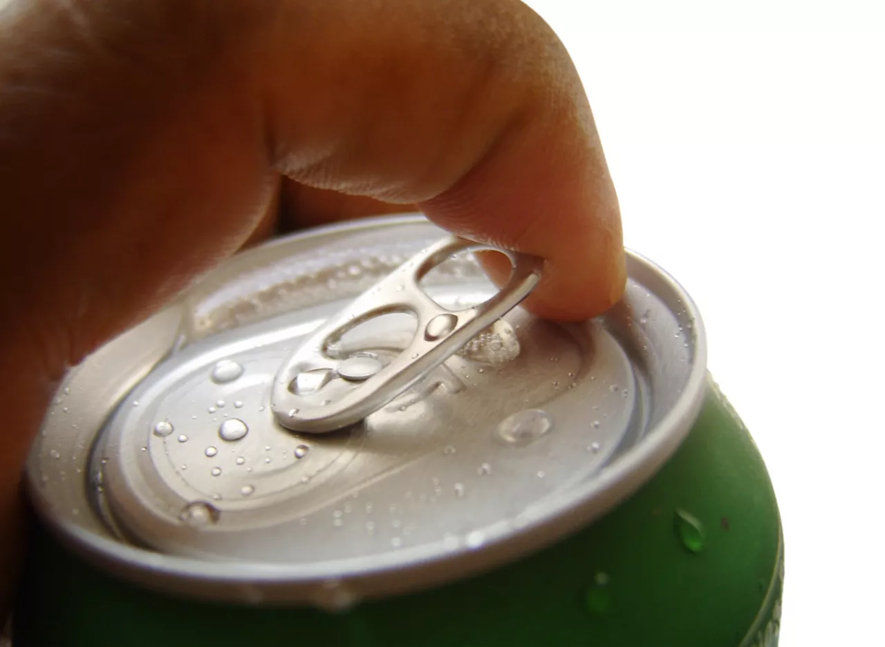 Hand opening a soda  