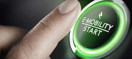 Finger pressing button labeled ‘E-Mobility Start’