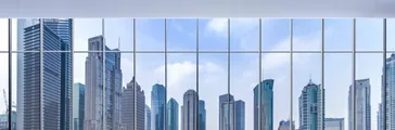 Skyscrapers viewed through window in an urban landscape.