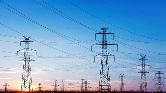 Landscape of power lines over a blue sky at sunrise or sunset