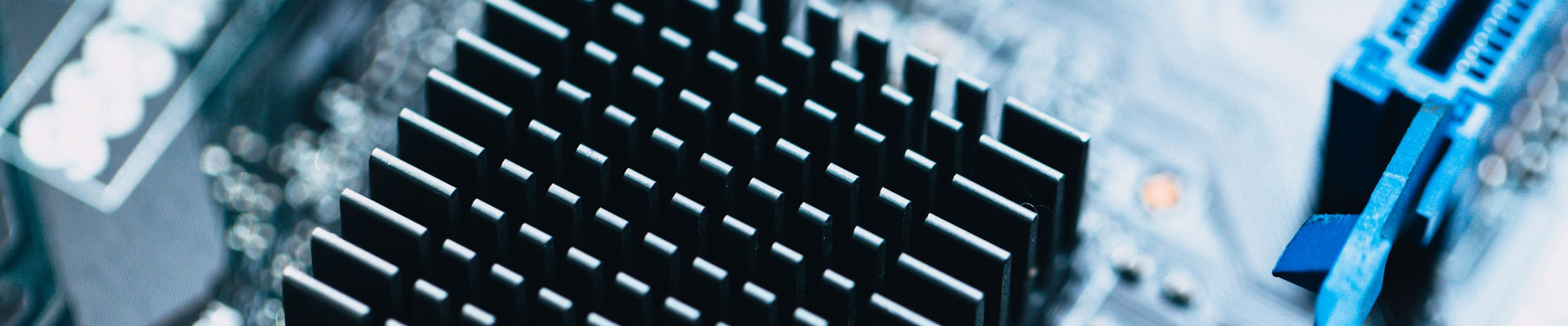 Macro photography of aluminum heat sink install at computer circuit board for cooling chips.