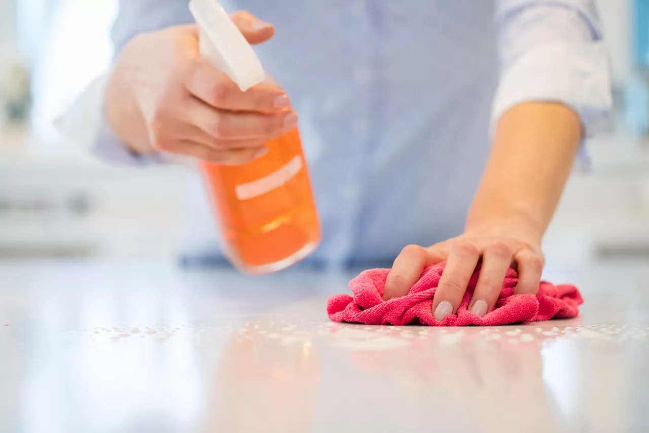 Woman washing countertop 