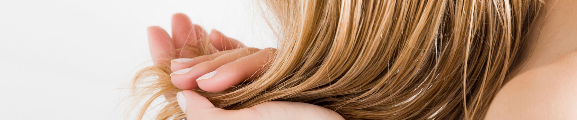 Young woman with hand touching her hair 