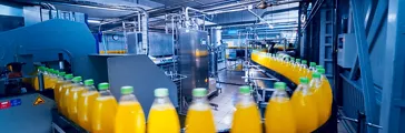 Beverage factory interior showing conveyor with bottles