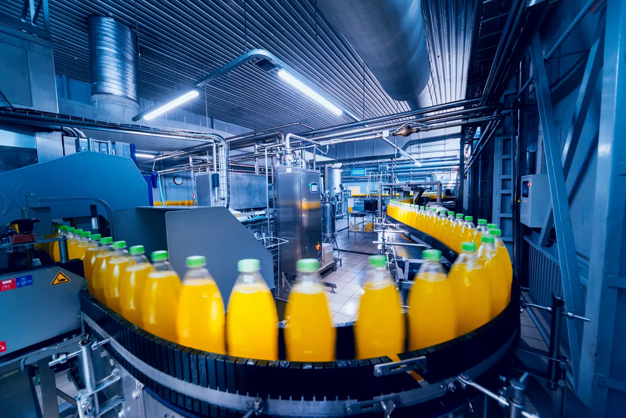 Beverage factory interior. Conveyor with bottles for juice or water. Modern equipments