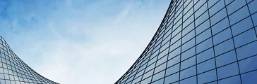 View of the clouds reflected in the curved glass office building. 3d rendering.
