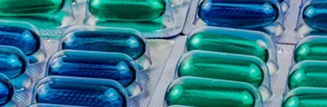 Blue and green soft gel capsule pills in blister pack 