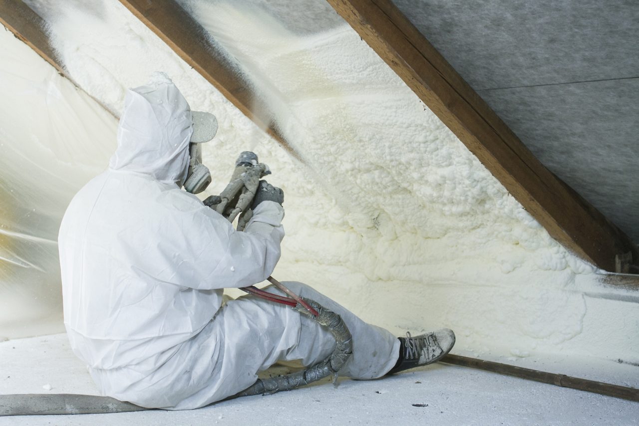 Man covered in white spraying on the wall 