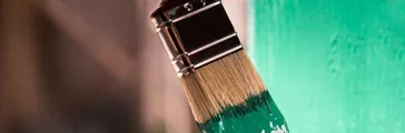 Paint brush coated in green paint