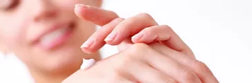 Woman putting on lotion  