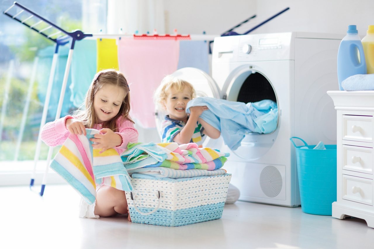 Children in laundry room helping with laundry