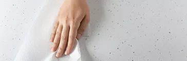 Woman wiping light table with paper towel