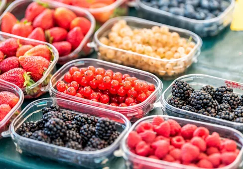 Plastic containers filled with red fruit