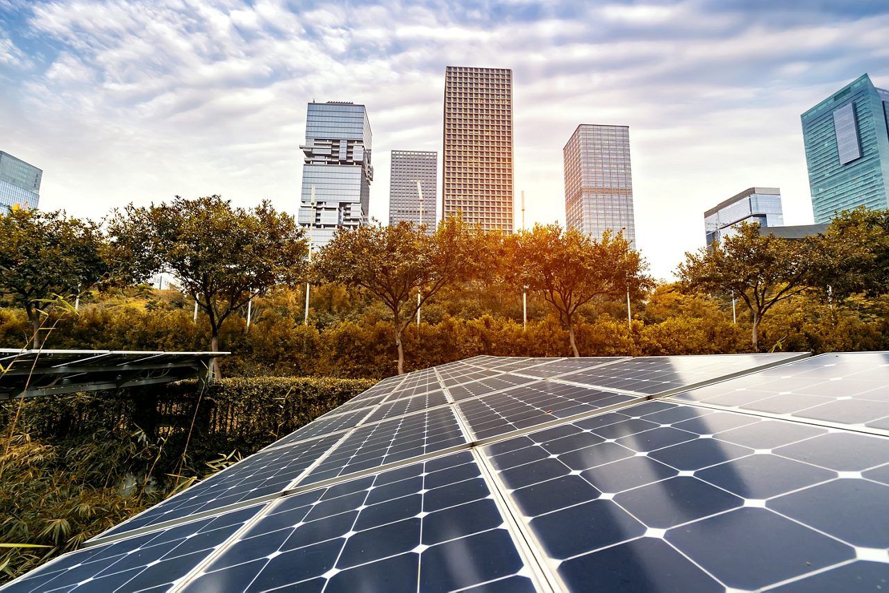 Ecological energy renewable solar panel plant with urban landscape landmarks