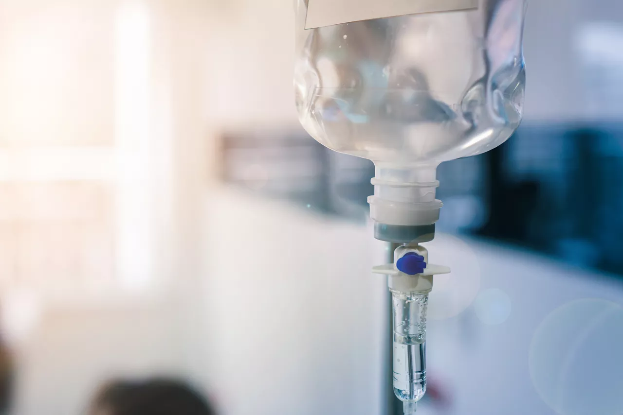 Close up of medical drip or IV drip chamber in patient room, Selective focus 