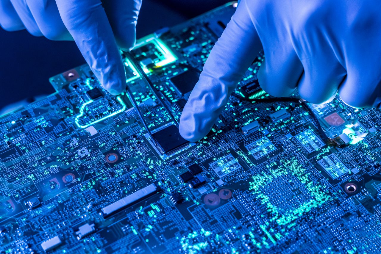 Fingers touching electrical board 