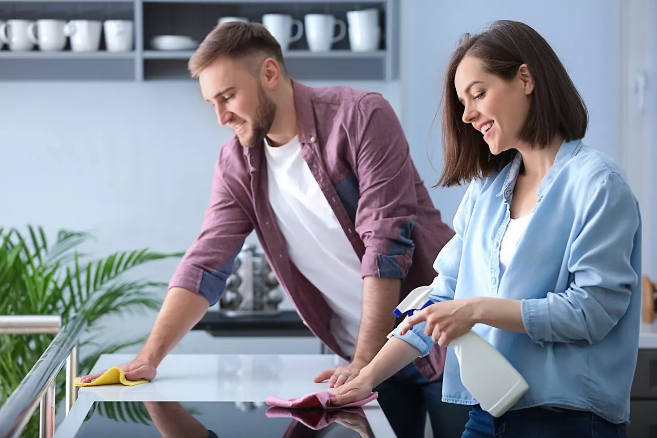 Young couple cleaning kitchen together