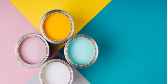 Four open cans of paint on bright symmetry background. Yellow, white, pink, turquoise colors of paint. Place for text. Renovation concept.