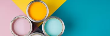 Four open cans of paint on bright symmetry