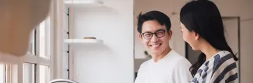 Asian couple family washing dishes together at kitchen.