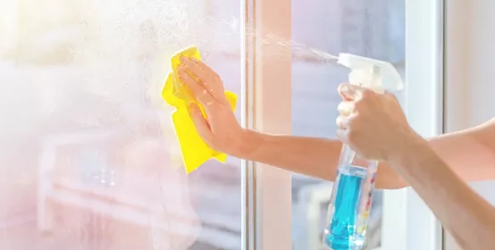 Hands with napkin cleaning window