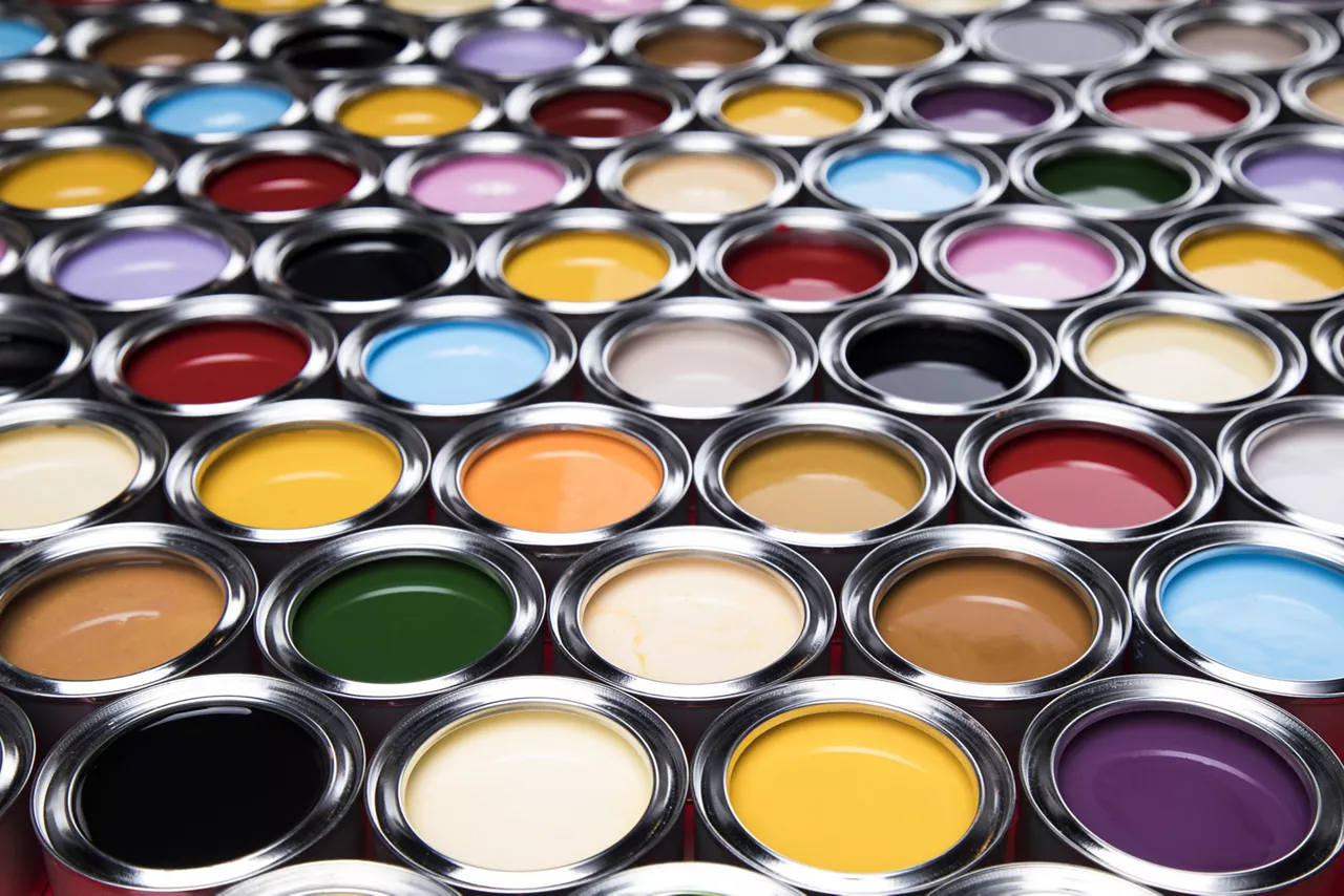 Open paint cans of different colors background