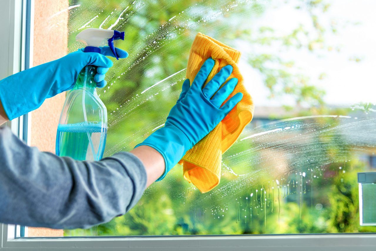 Cleaning window pane with detergent, spring cleaning concept