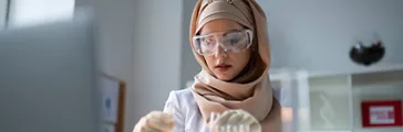 Test tubes. Young chemist wearing gloves working with test tubes full of chemical agents