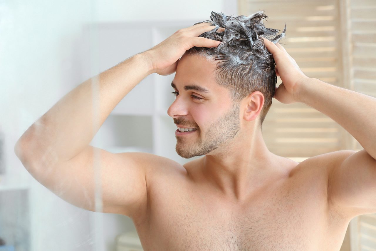 Man washing hair in shower