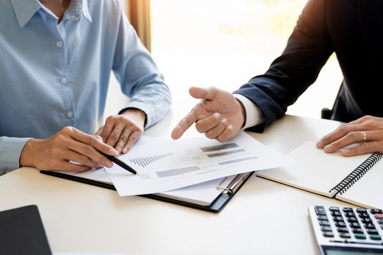 wealth management concept, business man and team analyzing financial statement for planning financial customer case in office