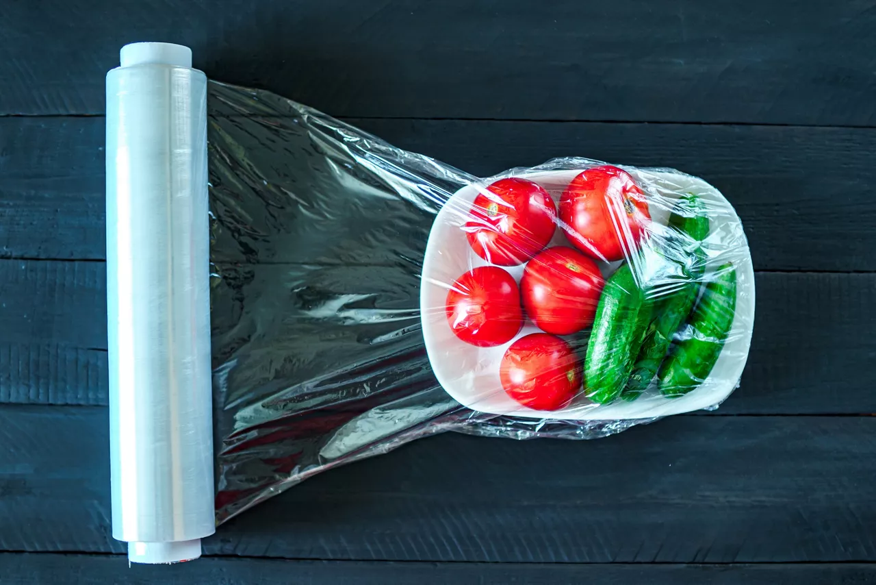 Using food film for vegetables storage in fridge. Top view