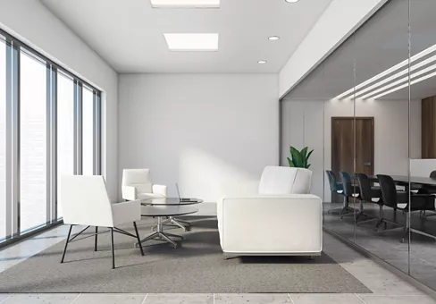Office lounge with dark wooden and white walls, tiled floor, white sofa and armchairs and two round coffee tables with laptop standing on the carpet. Conference room next to it. 3d rendering